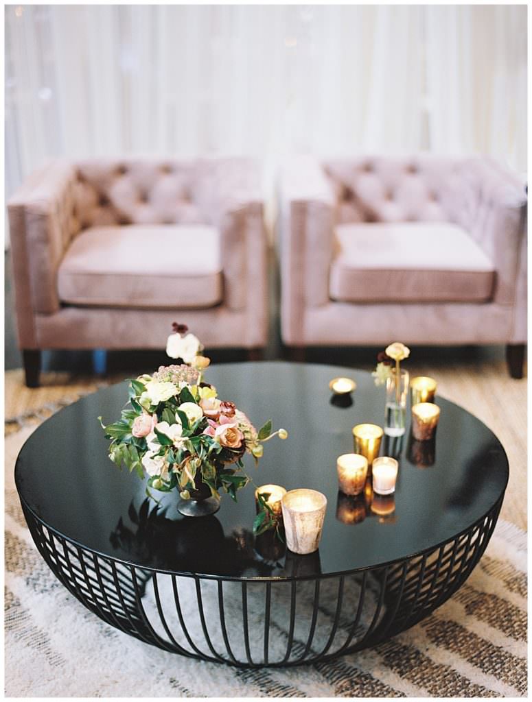 Relaxing scene of candles, flowers and chairs