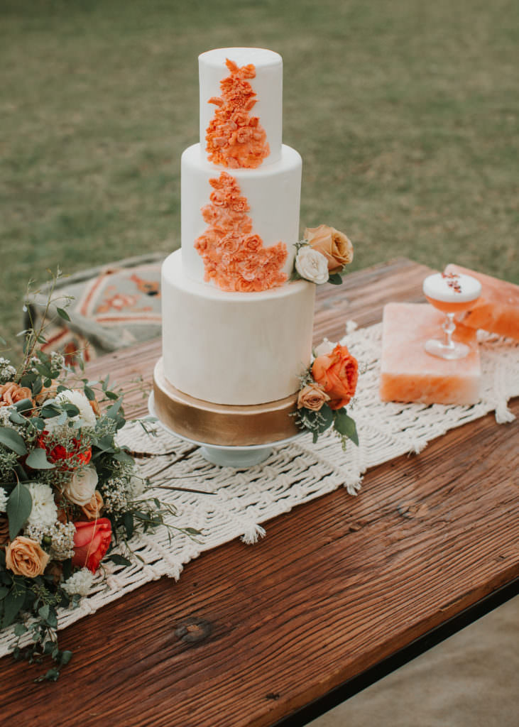 3 tier wedding cake with orange flowers