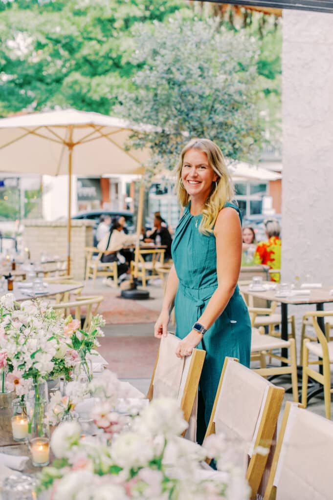 Sarah Chancey at a decorated table | Founder of Chancey Charm weddings