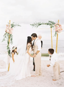 Bride and groom first kiss at beach wedding at Rosemary beach