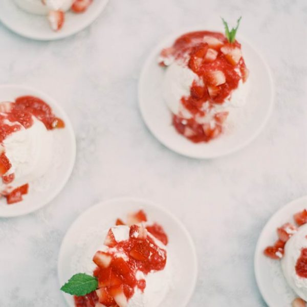 Wedding white mini desserts with red sauce