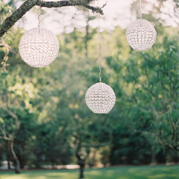 White circular lights hanging from a treee
